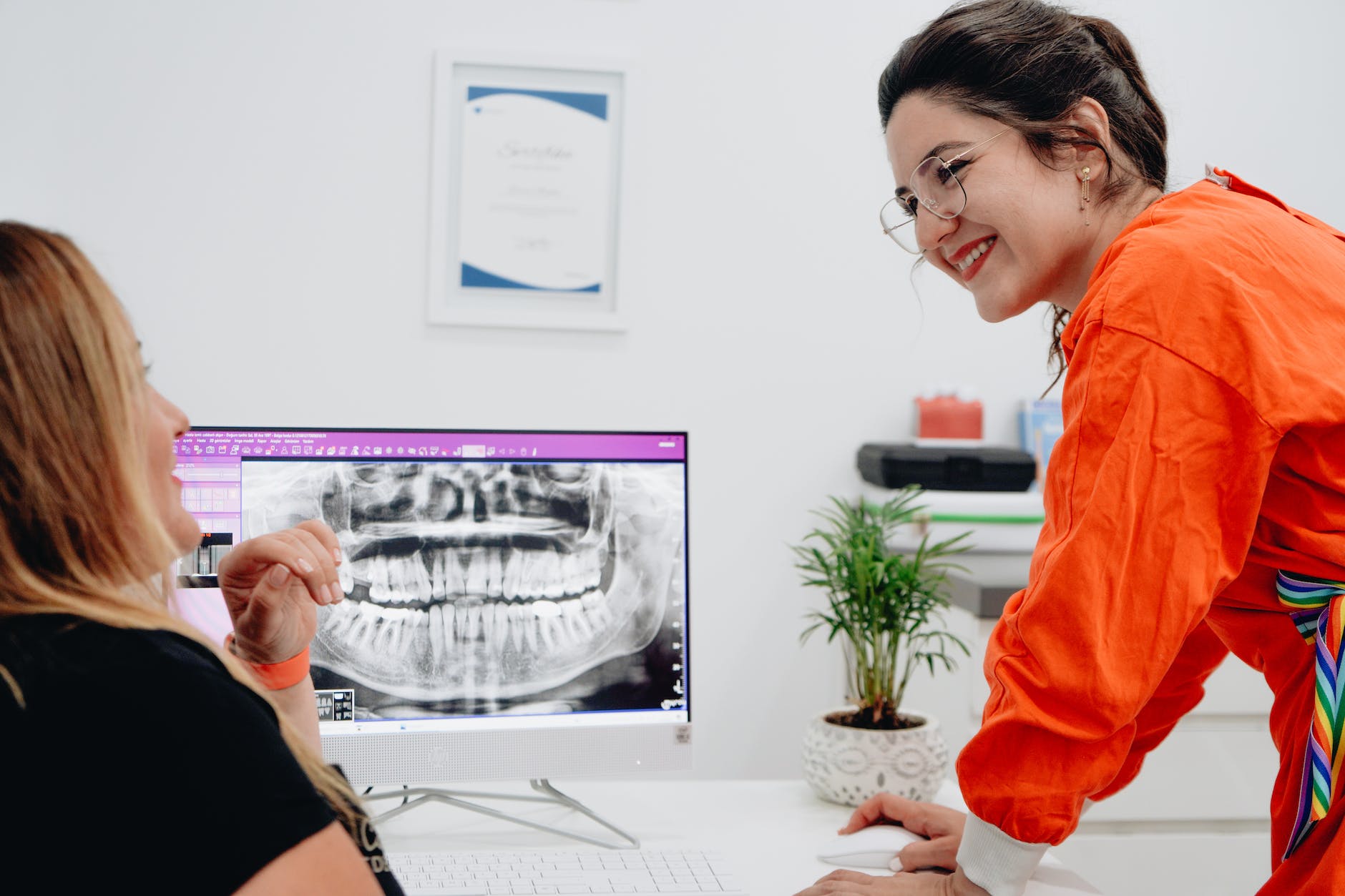 women looking at a dental x ray on a computer